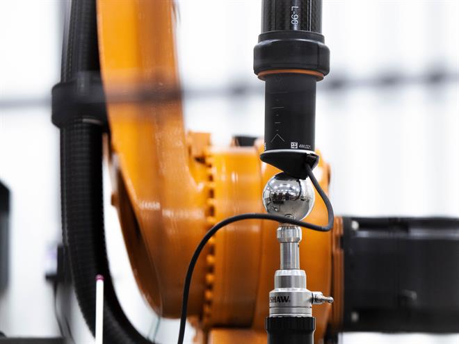 Renishaw industrial automation RCS L-90 ballbar fitted between a robot arm and datum sphere within a robot cell
